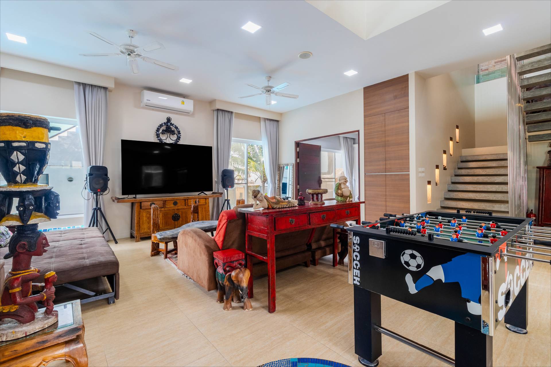 Games room with foosball table and big screen TV