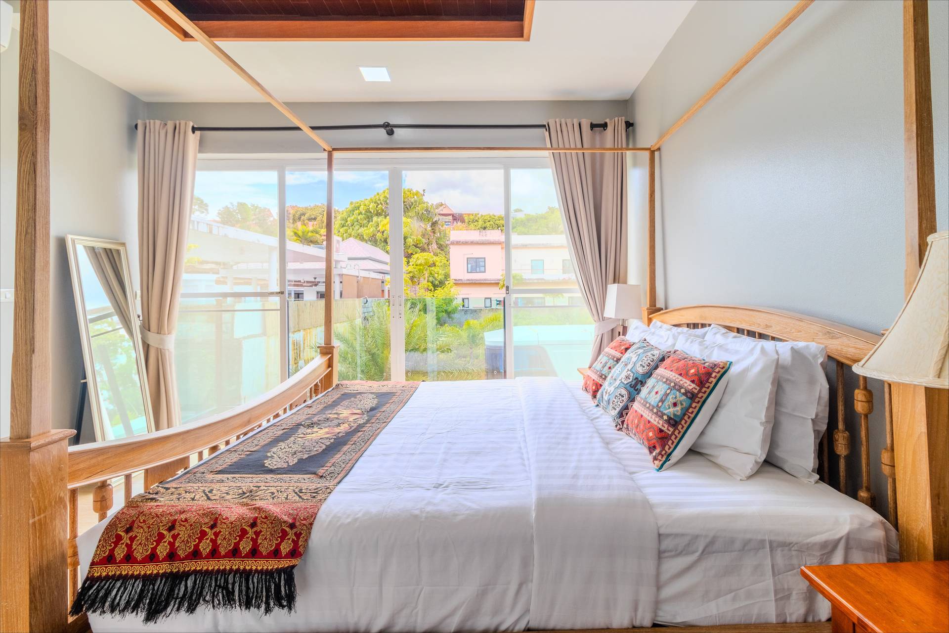 Four-poster teak bed with Thai silk runner