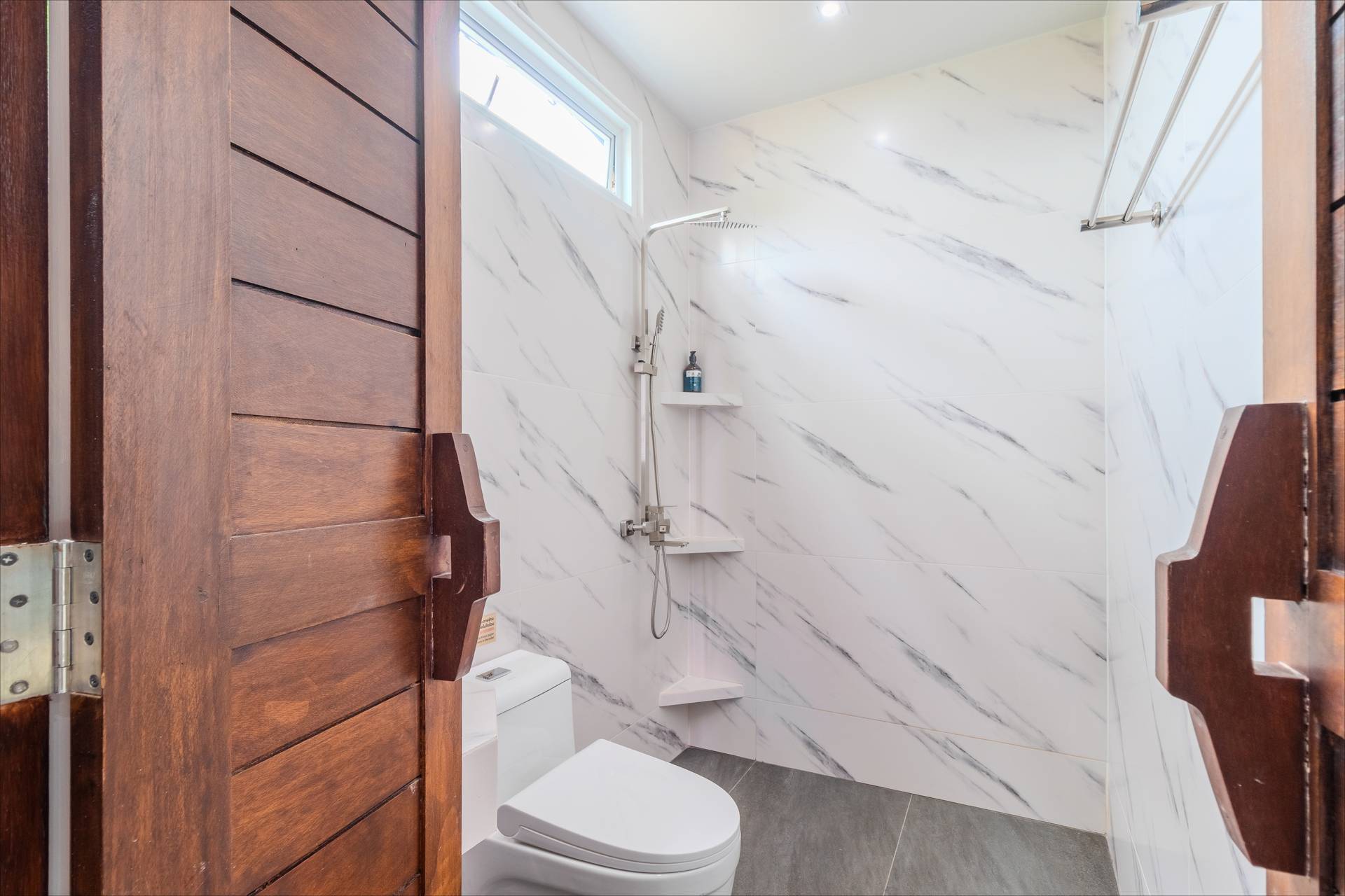 Walk-in rain shower with marble tiles