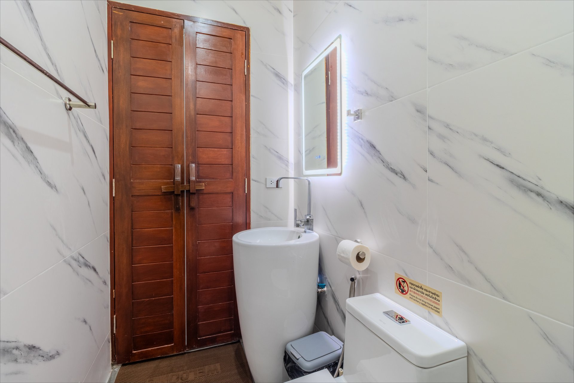 Modern bathroom with LED-lit mirror