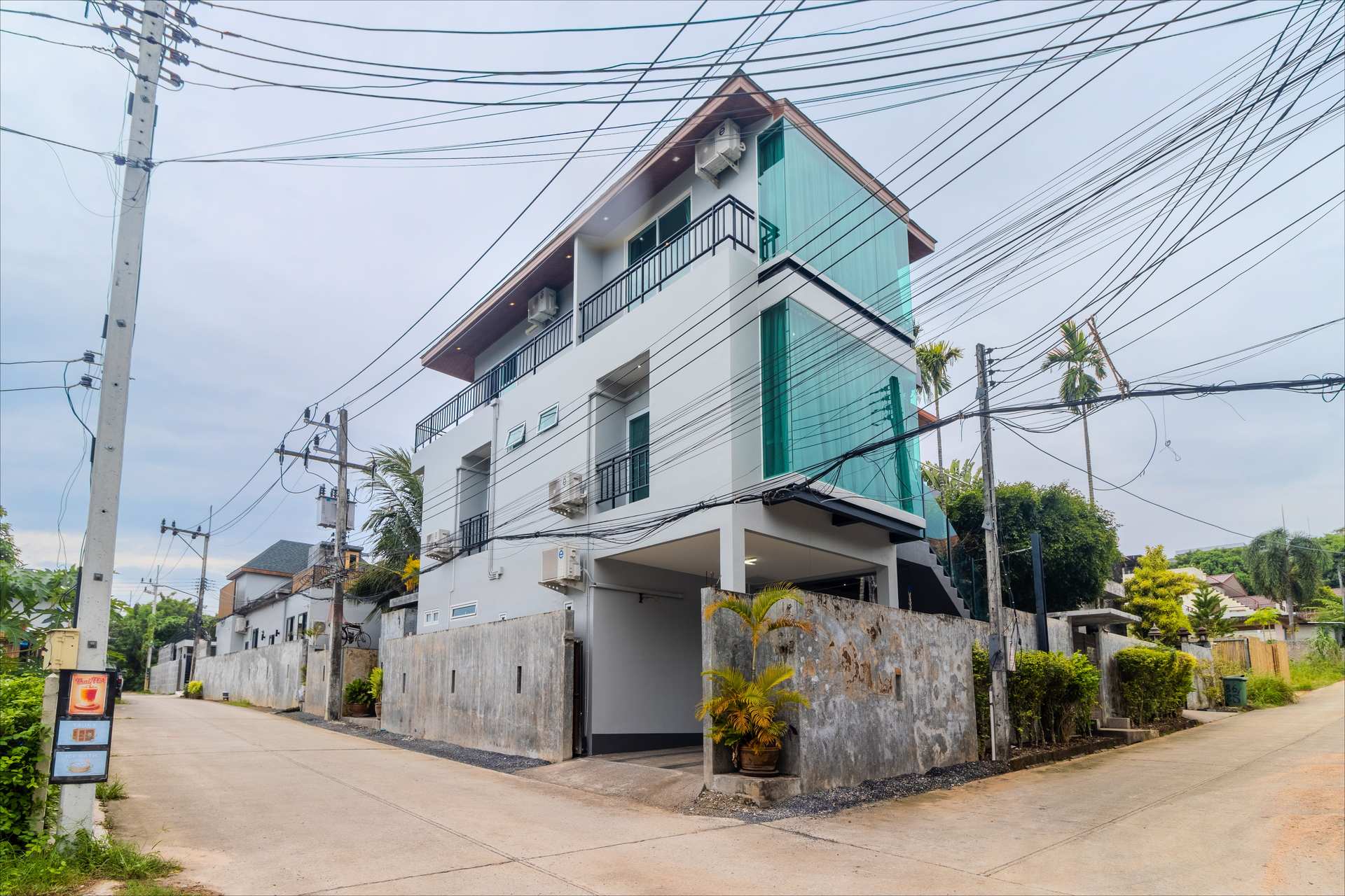 Three-storey villa with turquoise glass balconies