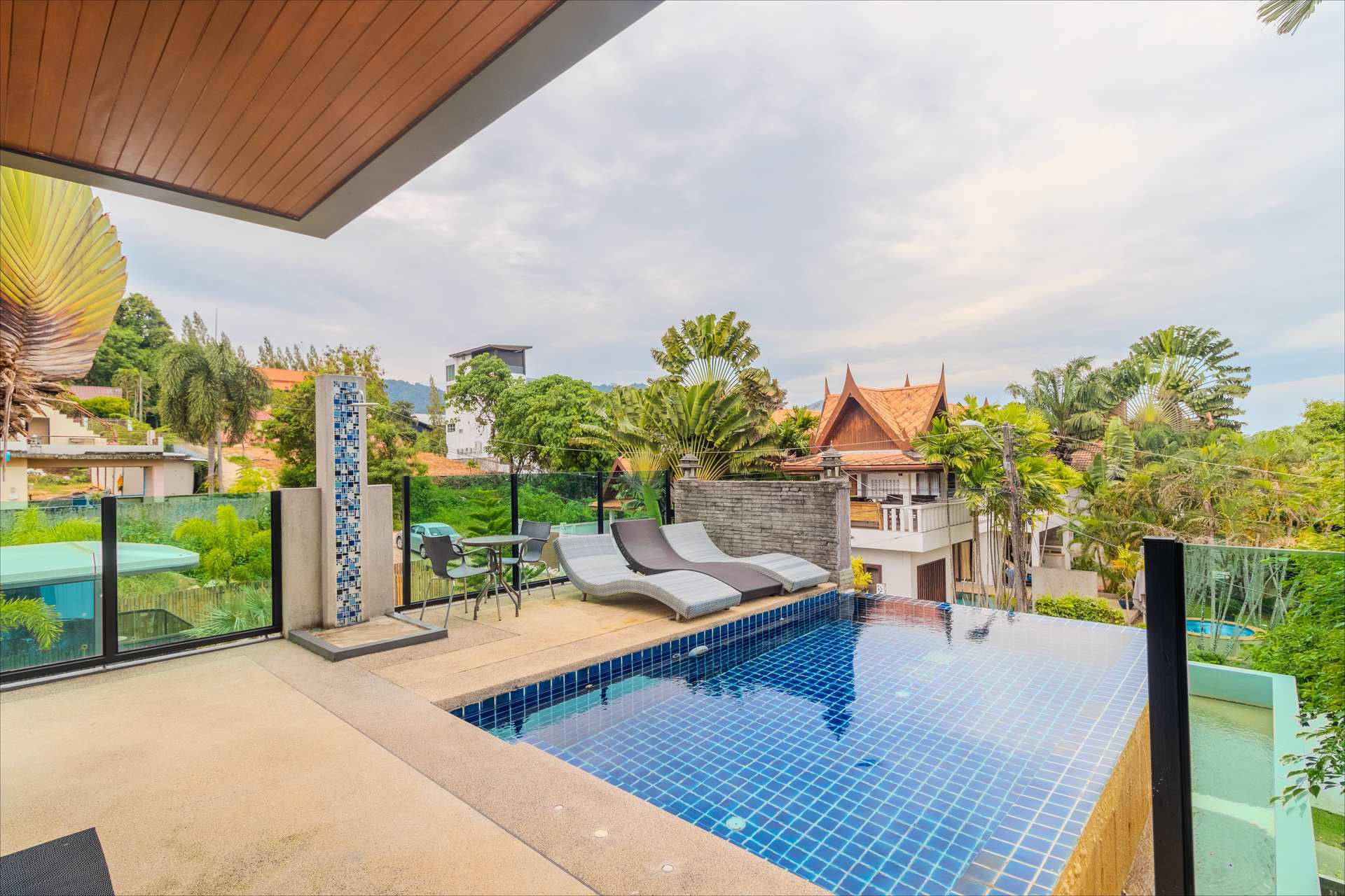 Rooftop pool at dusk with panoramic hillside views
