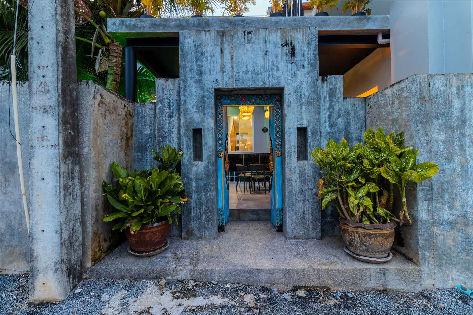 Garden entrance with turquoise door at dusk